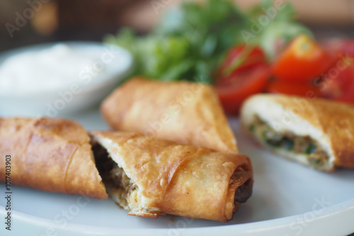 Enjoy Crispy Spring Rolls stuffed with Fresh Vegetables and served with a tasty Dipping Sauce