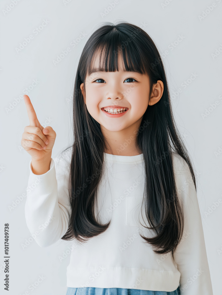 Young girl with long hair wearing a white sweater happily raising her finger indoors to signal an exciting idea or discovery. Young girl with long hair wearing a white sweater happily raising her finger indoors to signal an exciting idea or discovery.