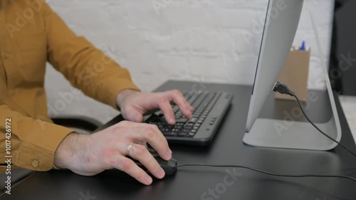 Side View of Hands Typing on Keyboard of Computer