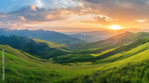 A panoramic view of rolling green mountains illuminated by a golden sunset.