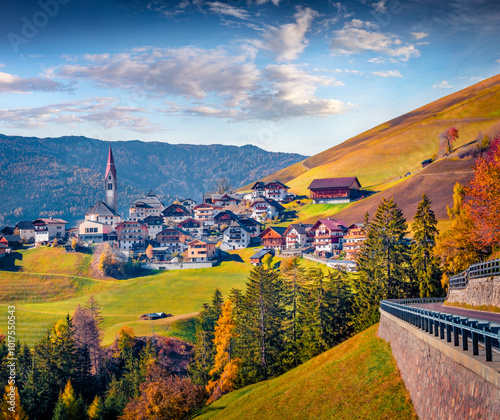 Impressive autumn view of Pfarrei Maria vom Guten Rat Christian church, Italy, Europe. Magnificent morning scene of Dolomite Alps. Traveling concept background.