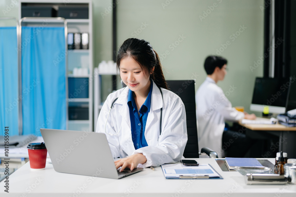Confident young female doctor in white medical uniform sit at desk working on computer. Confident young female doctor in white medical uniform sit at desk working on computer.