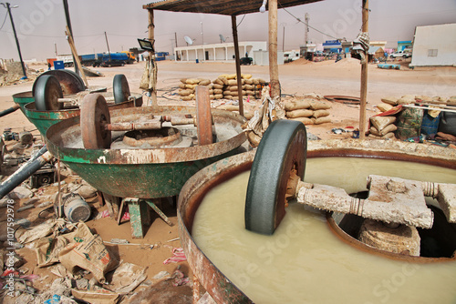 Obraz na płótnie Nouakchott, Mauritania - 06 Jan 2022: Factory next to a gold mine in Sahara desert not far Nouakchott, Mauritania, West Africa w salonie