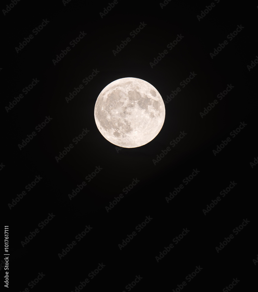 Bright harvest full moon isolated against black night sky. Bright harvest full moon isolated against black night sky.