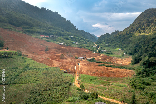 A vast valley in Dong Van, Ha Giang province, Vietnam surrounded by majestic limestone mountains. The steep, towering cliffs create a wild and majestic natural picture. photo