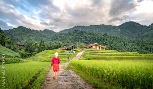 Nam Hong Community Tourism Village, Ha Giang Province, Vietnam - September 17, 2024: A female tourist walks on the village road. The beautiful scenery of Nam Hong Village, Ha Giang Province, Vietnam.  photo