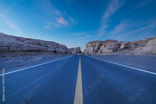 Asphalt road and Yardang landform mountain natural landscape at night. Car background. photo