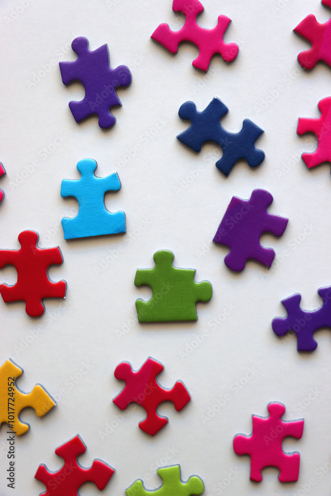 Obraz premium Colorful jigsaw puzzle pieces on white background. Flat lay.