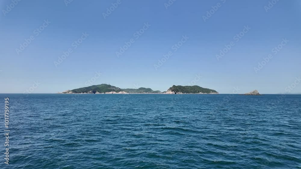 맑고 파란 하늘 아래 바다에서 바라본 먼 섬들 맑고 파란 하늘 아래 바다에서 바라본 먼 섬들