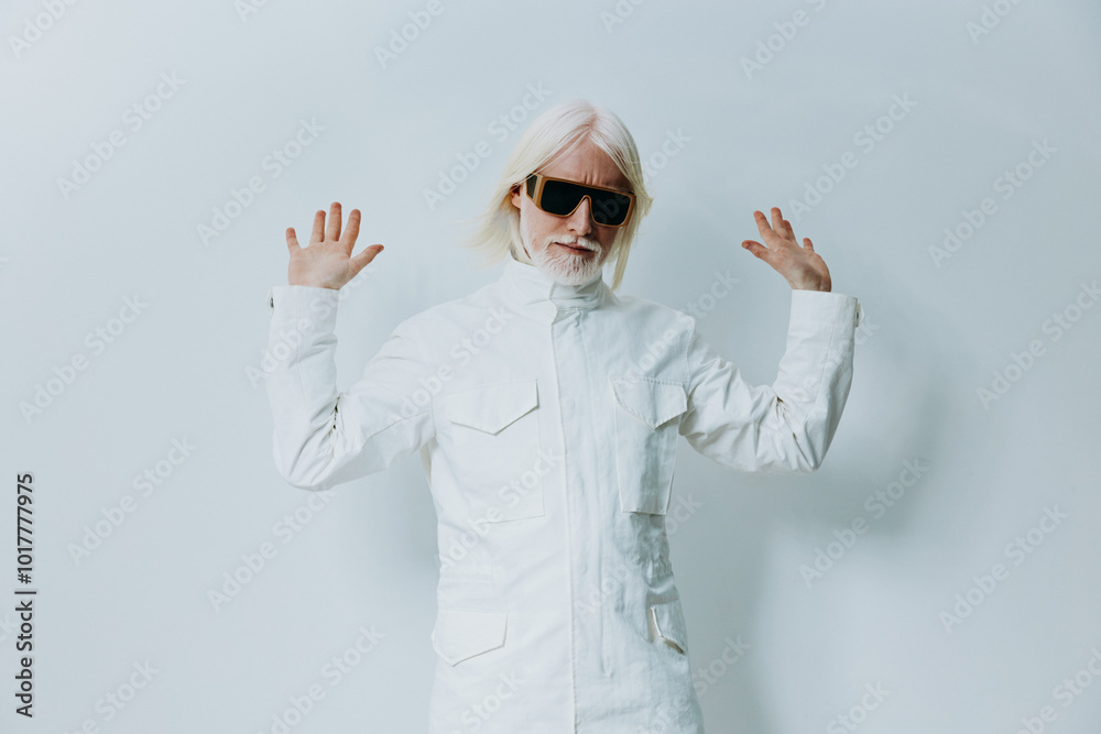 Stylish man posing with hands raised in a modern white outfit against a minimalist light background, creating a vibe of confidence and fashion Stylish man posing with hands raised in a modern white outfit against a minimalist light background, creating a vibe of confidence and fashion