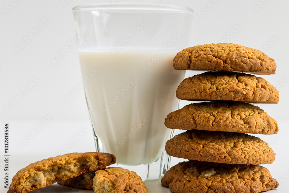 White and milk cookies on. food sweet dessert concept. stack of oatmeal cookies on a white with a glass of milk. a stack of oatmeal and cookies on a white with glasses of lifestyle milk. White and milk cookies on. food sweet dessert concept. stack of oatmeal cookies on a white with a glass of milk. a stack of oatmeal and cookies on a white with glasses of lifestyle milk.