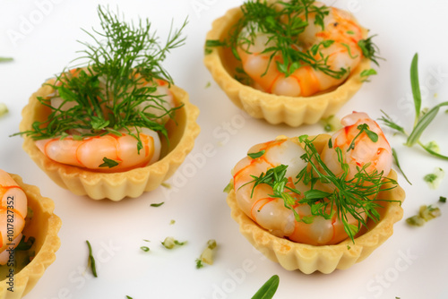 A plate of food with a shrimp and tartlet as an appetizer. Delicious tasty tartlet concept. A small plate of tartlets with shrimps and herbs on it. A plate of appetizers with and shrimps, shrimps,.