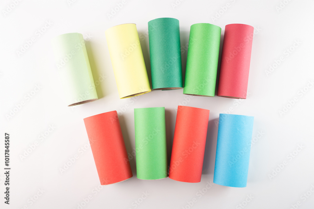 Fototapeta premium recycled toilet paper roll tubes wrapped in colored paper, step in creative process of making festive garland, DIY, project,