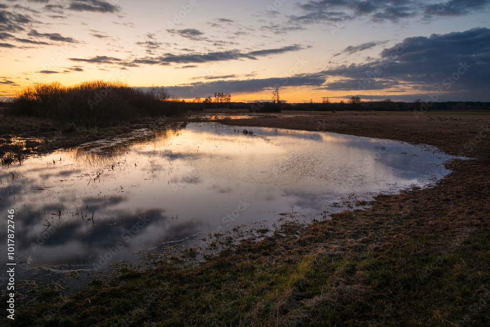 Flood water on the meadow and the evening sky, eastern Poland Flood water on the meadow and the evening sky, eastern Poland