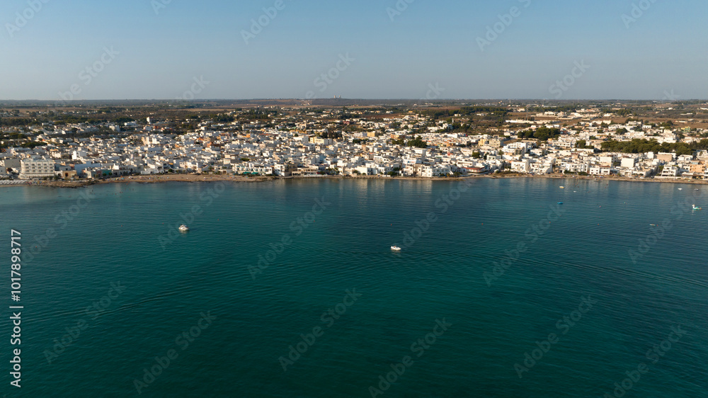 Obraz premium Aerial view of Porto Cesareo at sunset. It is a small city on the Mediterranean Sea in the province of Lecce, Italy. It is a tourist town located on the Ionian coast of the Salento peninsula.