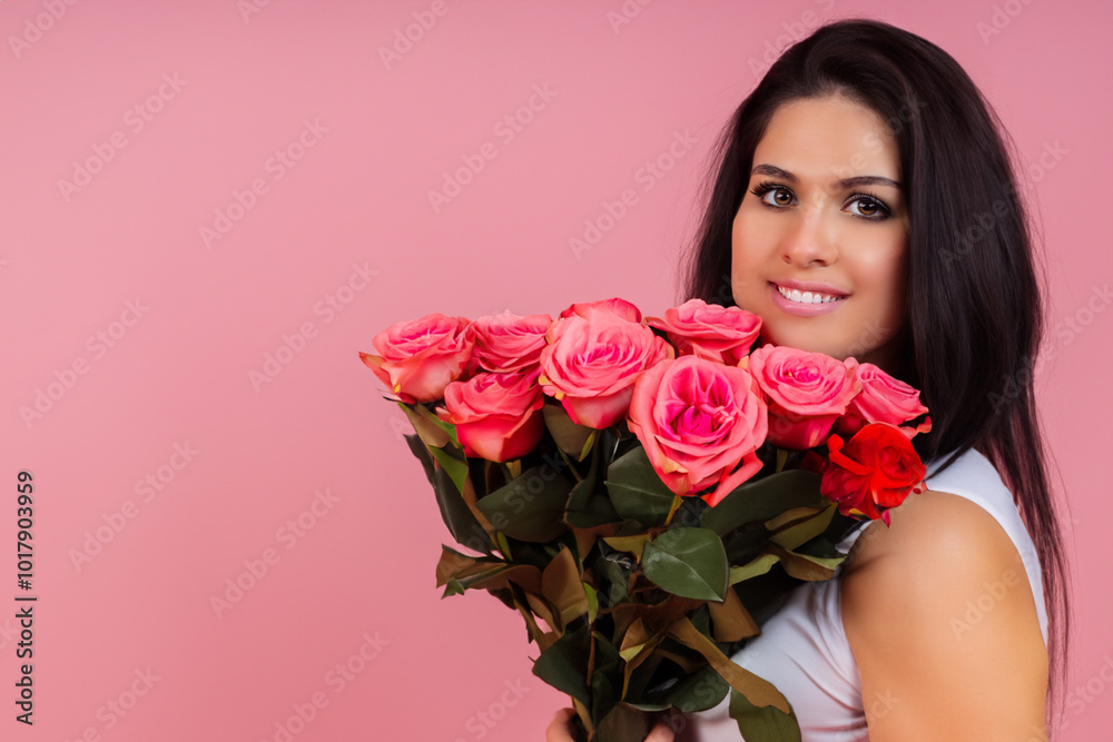 Girl in pink and white with roses on the . pretty portrait showing concept. girl standing with bouquet of roses on a pink . a girl standing on a white with a bouquet of lifestyle pink roses.