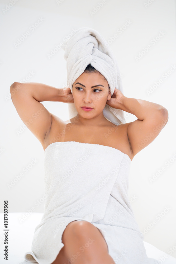 Beautiful young woman is drying her hair with a towel after a relaxing shower Beautiful young woman is drying her hair with a towel after a relaxing shower
