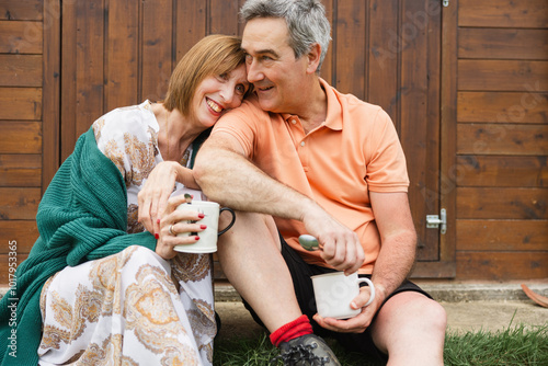 Relaxed couple enjoying coffee outdoors in the countryside photo