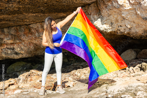 woman, middle aged, outdoors waving pride flag, concept of libertat, equality photo