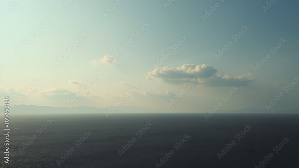 Vast Barren Landscape Under Wide Sky: Perfect for Solitude Themes, Environmental Campaigns, or Minimalist Design Projects Vast Barren Landscape Under Wide Sky: Perfect for Solitude Themes, Environmental Campaigns, or Minimalist Design Projects