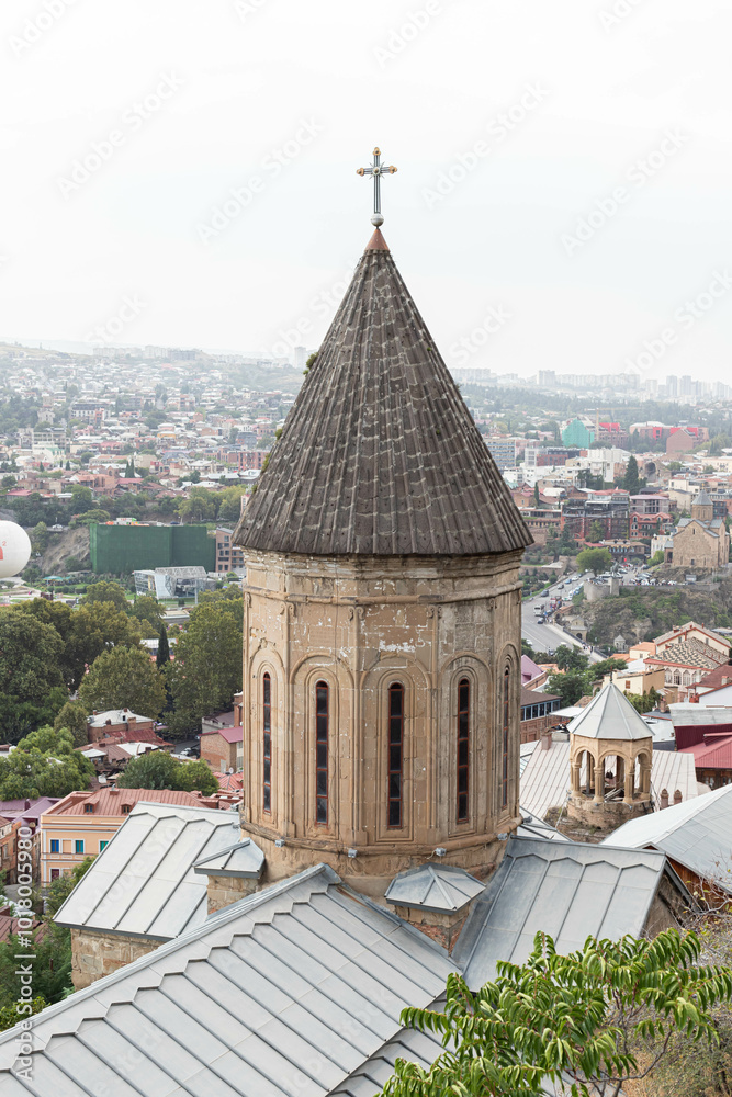 Obraz premium A historic church tower Norashen with a cross rises above the rooftops, Tbilisi, Georgia - 10 September, 2024