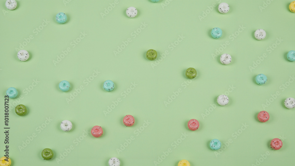 Pastel Green Background with Scattered Candy-Like Objects: Perfect for Confectionery Ads or Spring-Themed Designs Pastel Green Background with Scattered Candy-Like Objects: Perfect for Confectionery Ads or Spring-Themed Designs