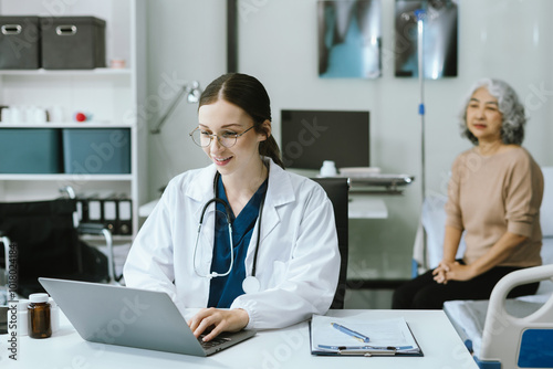 Doctor sitting at table and writing on a document report in hospital office. Medical healthcare staff and doctor service.