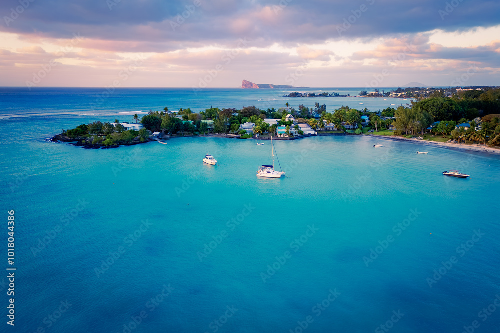 Drone view of the greater Grand Baie area on Mauritius, with its beautiful estates and beaches, Cap Malheureux and Gunner's Quoin in the background Drone view of the greater Grand Baie area on Mauritius, with its beautiful estates and beaches, Cap Malheureux and Gunner's Quoin in the background