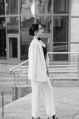 Stylish Businesswoman in Striped Suit with Modern Urban Background