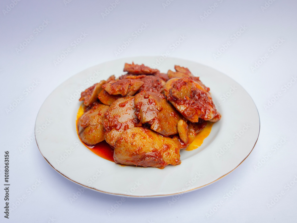 Jengkol Balado or dogfruit with red chili sauce, a spicy traditional Indonesian dish from West Sumatra, served on a white plate with a clean white background Jengkol Balado or dogfruit with red chili sauce, a spicy traditional Indonesian dish from West Sumatra, served on a white plate with a clean white background