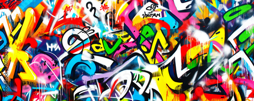Colorful graffiti on a white background, with numerous vibrant tags and symbols. Street art background texture.