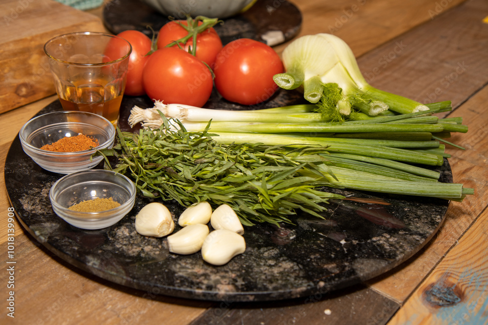 A selection of food ingredients on a wooden kitchen table ready to be cooked A selection of food ingredients on a wooden kitchen table ready to be cooked