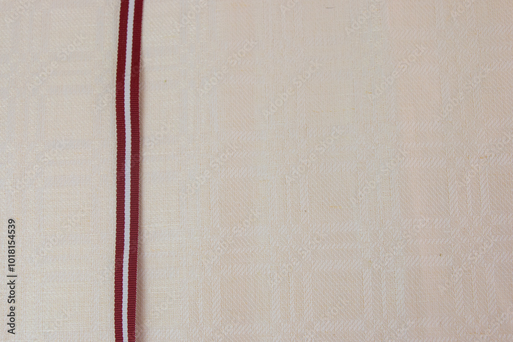 flag, red and white ribbon, symbol of independence day, on linen fabric ...