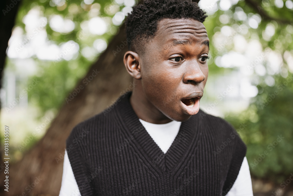 Surprised Young African Man Outdoors Expressing Amazement in Nature Surprised Young African Man Outdoors Expressing Amazement in Nature