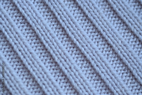 Macro texture of elastic of wool blue crocheted sweater as background, close-up of pastel blue crocheted front, blue crocheted back, texture of wool wool, blue crocheted front