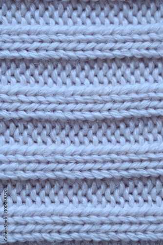 Macro texture of elastic of wool blue crocheted sweater as background, close-up of pastel blue crocheted front, blue crocheted back, texture of wool wool, blue crocheted front