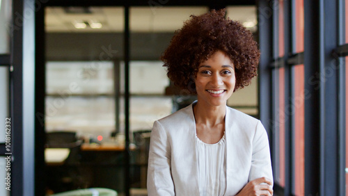 Slika na platnu Portrait Of Smiling Young Businesswoman Working In Modern Open Plan Office