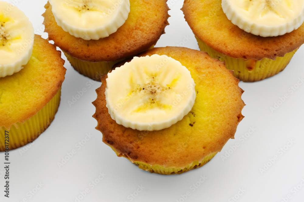 A white with cupcakes, bananas, and strawberries. Cupcake food bakery concept. A white and yellow cupcake with banana slices on a white . A white and yellow with bananas and small slices it on. A white with cupcakes, bananas, and strawberries. Cupcake food bakery concept. A white and yellow cupcake with banana slices on a white . A white and yellow with bananas and small slices it on.