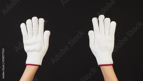 Hands is wear glove knitting on black background.