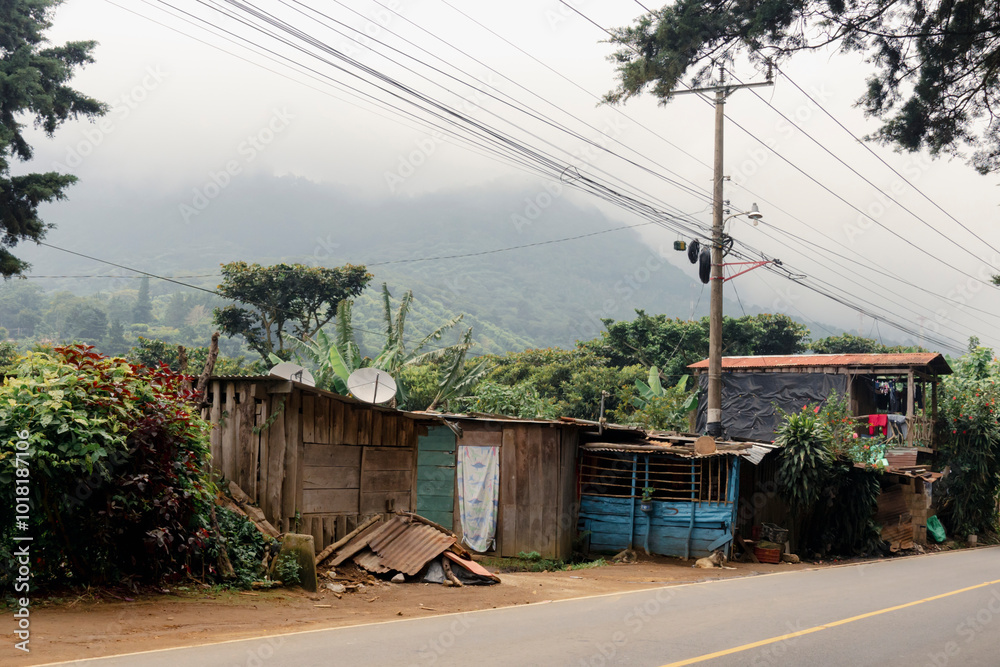 Rustic roadside home in El Salvador with lush green background Rustic roadside home in El Salvador with lush green background