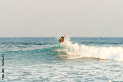 Unrecognizable surfer riding wave in El Salvador