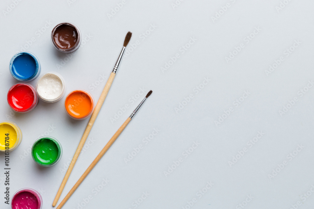 art palette with paint and brushes, close up. Top view with empty space. workplace for creativity. home teaching concept drawing art palette with paint and brushes, close up. Top view with empty space. workplace for creativity. home teaching concept drawing