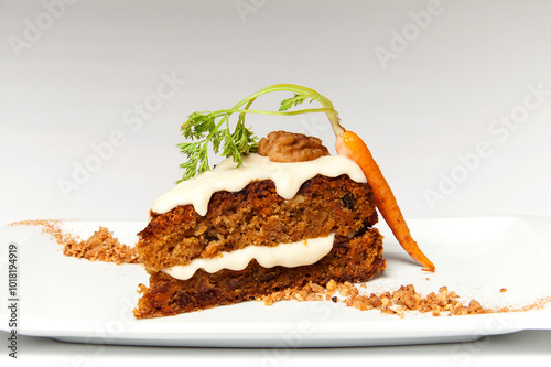Carrot cream sponge cake plate with crispy garnish on plate and white background