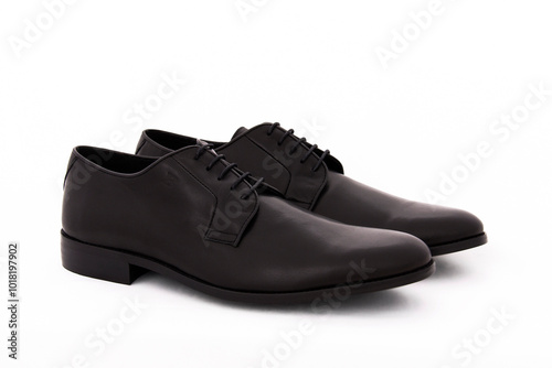 Pair of men's leather court shoes in black on a white background