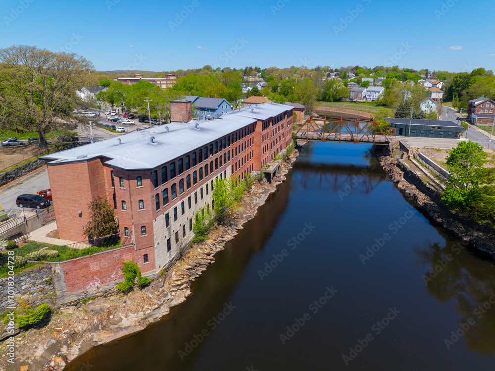 Fototapeta premium Sayles Street Bridge and Glenark Mills building on Blackstone River aerial view in downtown Woonsocket, Rhode Island RI, USA.