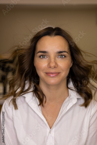 portrait of a beautiful girl in a white blouse with dark hair smiling