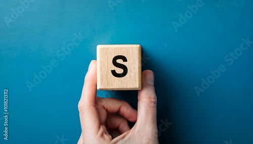 Hand hold wooden cube with letter s from idea concep photo