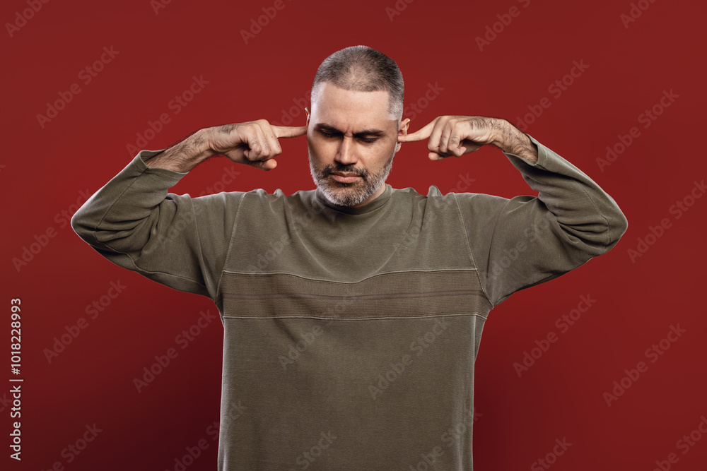 Fototapeta premium man covering his ears with his fingers