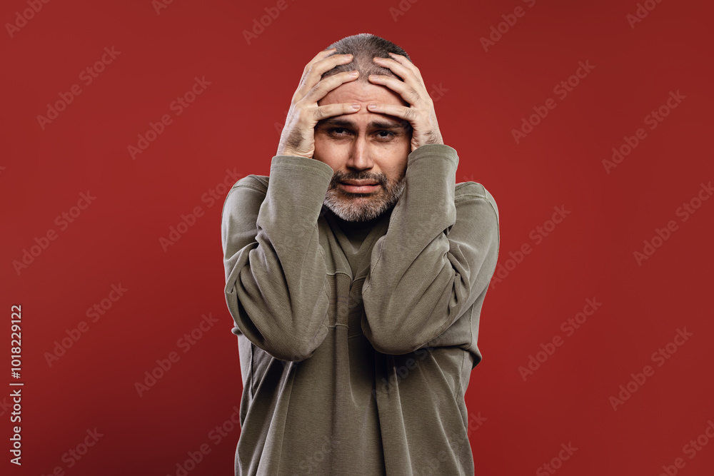 man feeling pain with hands on head man feeling pain with hands on head