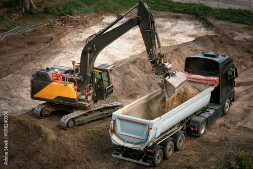 Obraz na płótnie Excavator loading dirt into a truck, view from above w salonie
